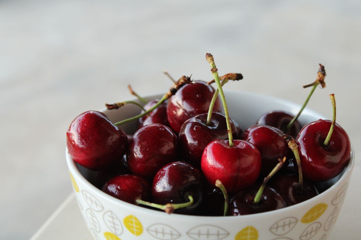 Cherries in a patterned ceramic bowl