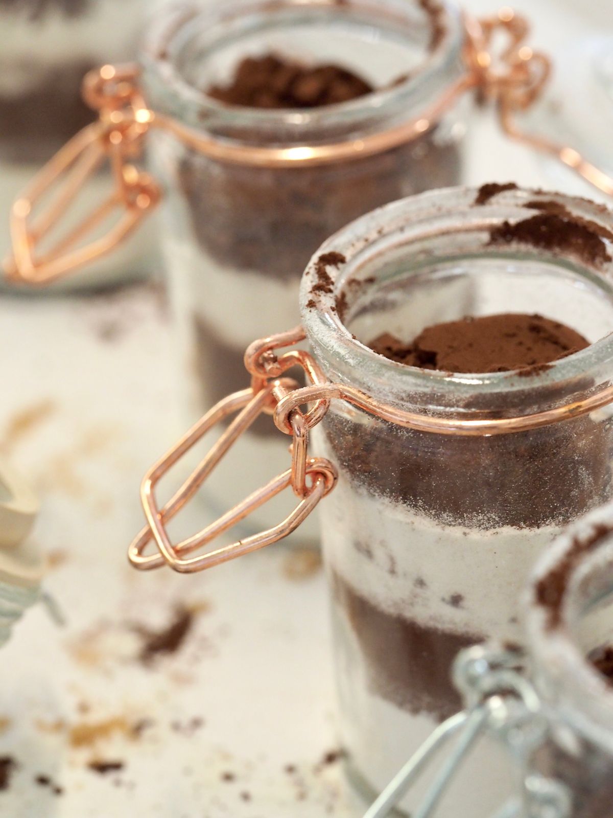 Cocoa powder in a glass jar beside icing sugar