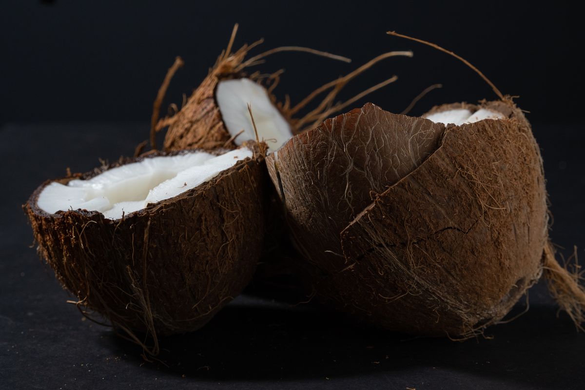 Coconut halves arranged on a dark surface