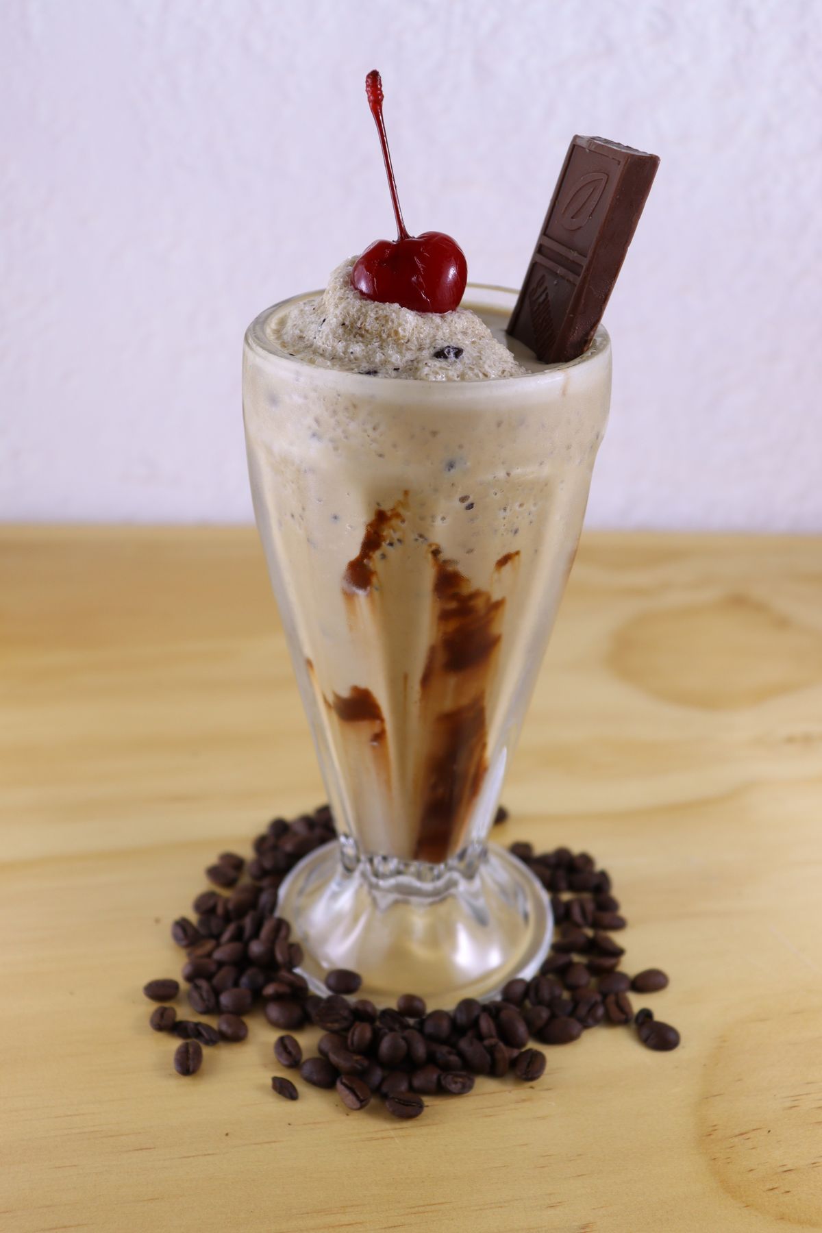 Coffee milkshake with cream, cherry and chocolate garnish