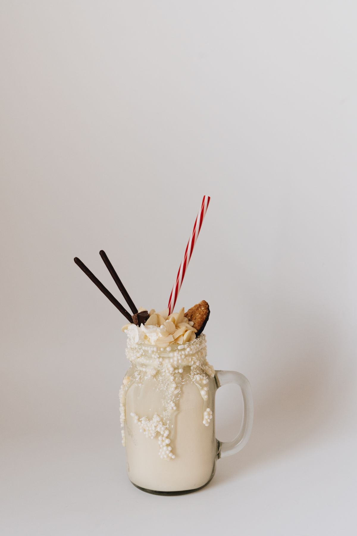 Creamy milkshake in a glass mug with cookie topping