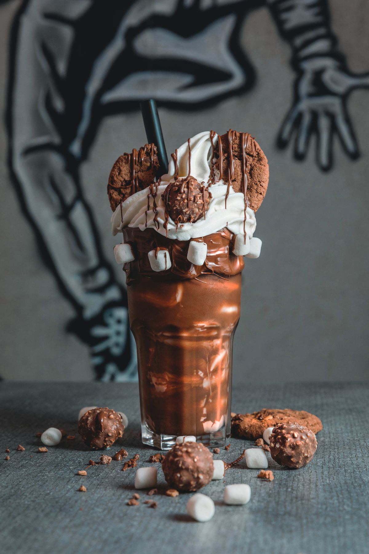 Milkshake decorated with whipped cream, marshmallows and cookies