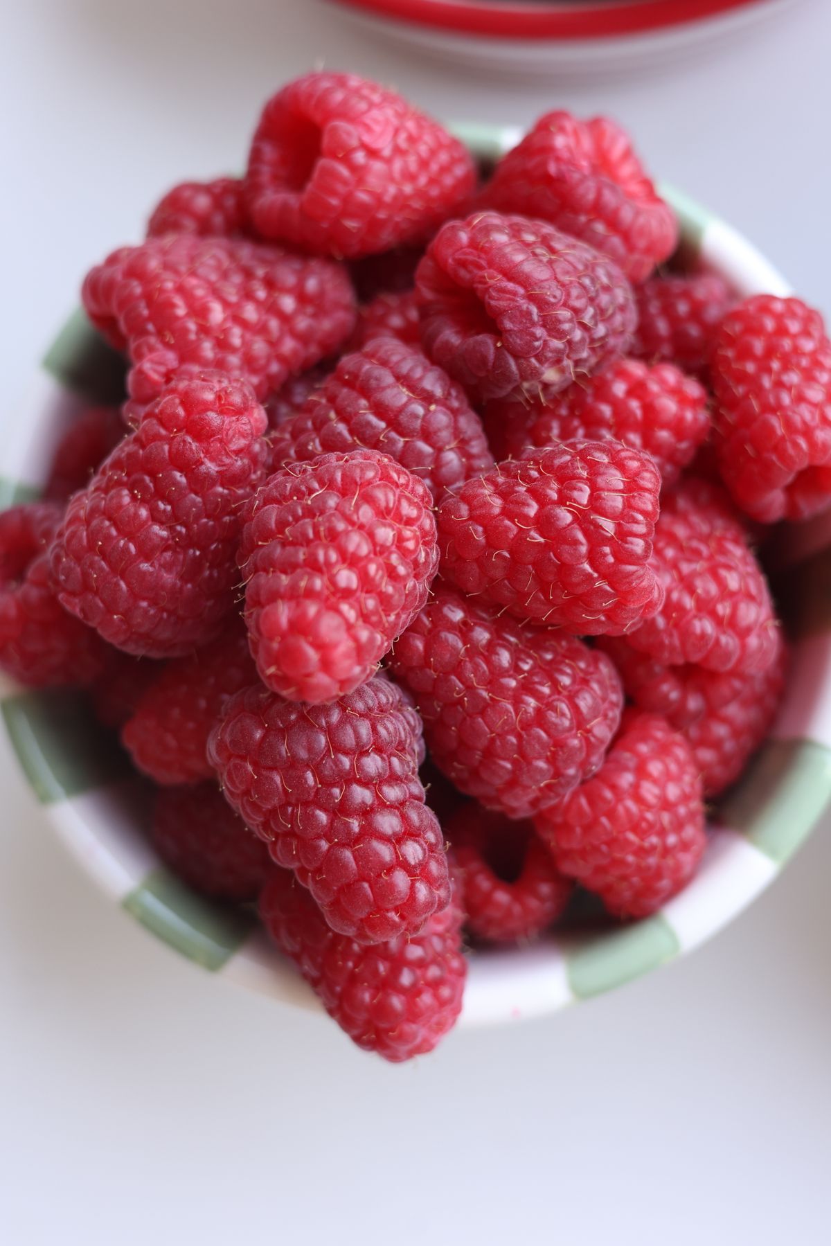 Fresh raspberries in a ceramic bowl