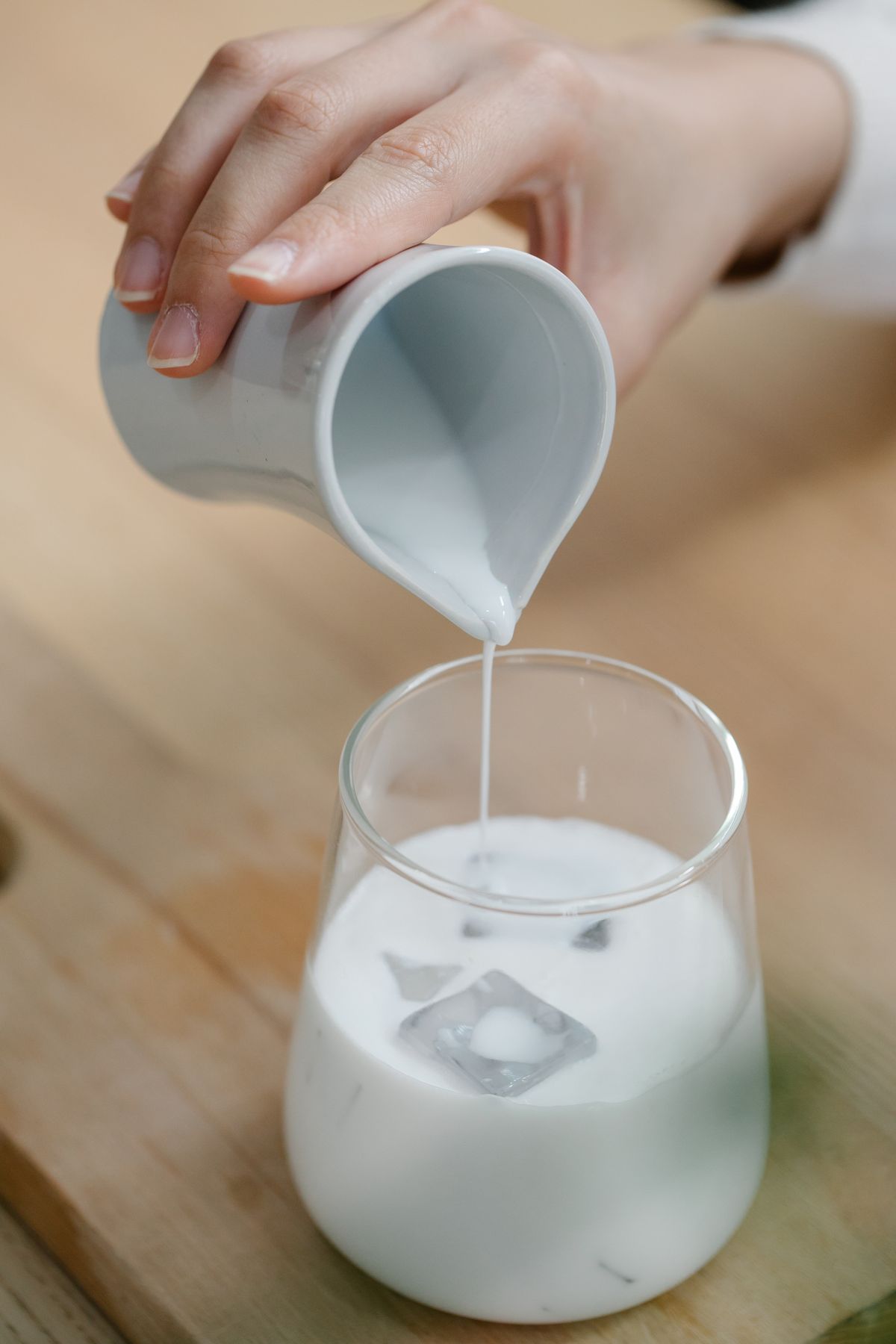 Milk poured over ice in a glass